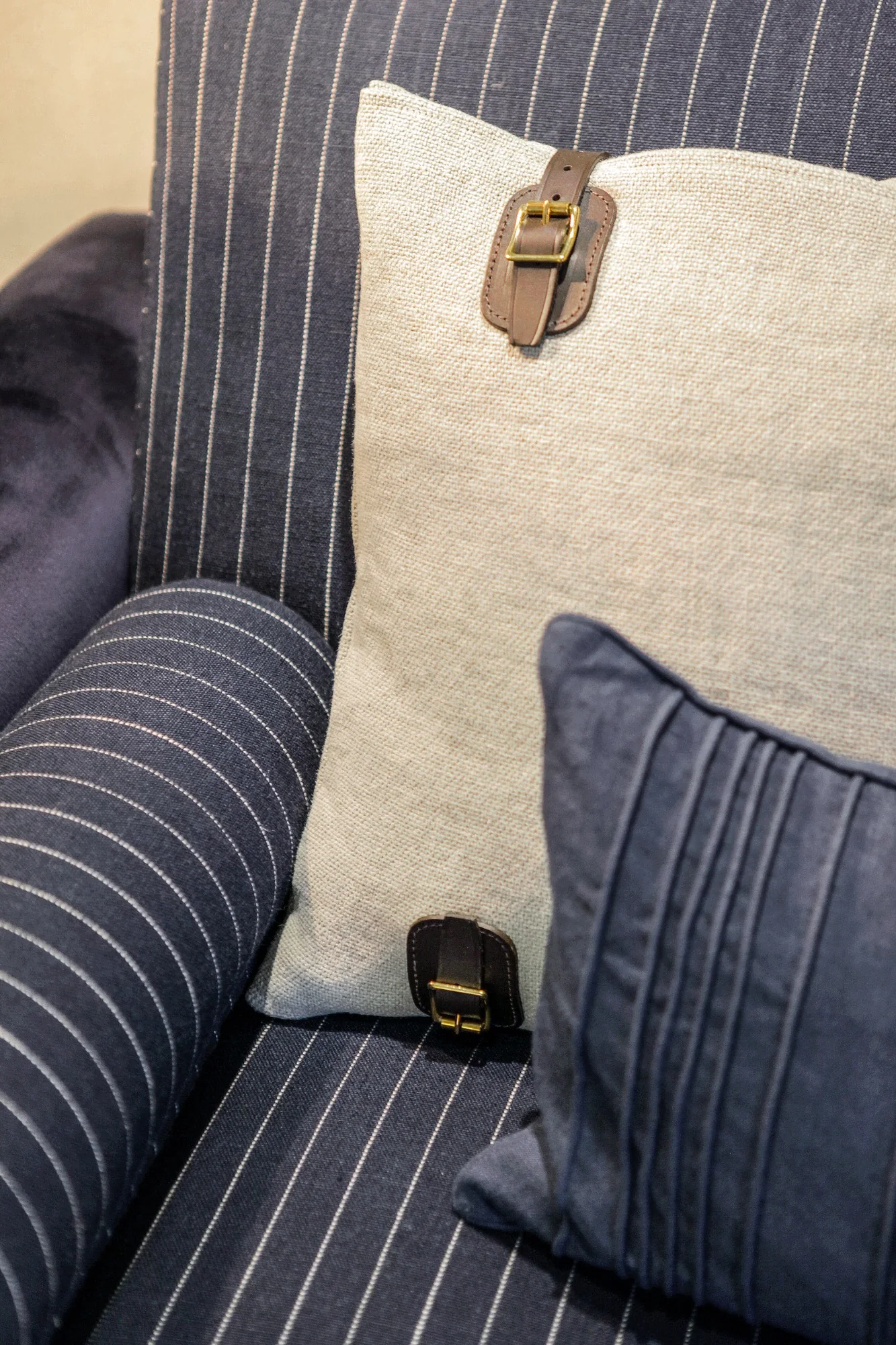 Detail of tailored striped upholstery and contrasting cushion fabrics.