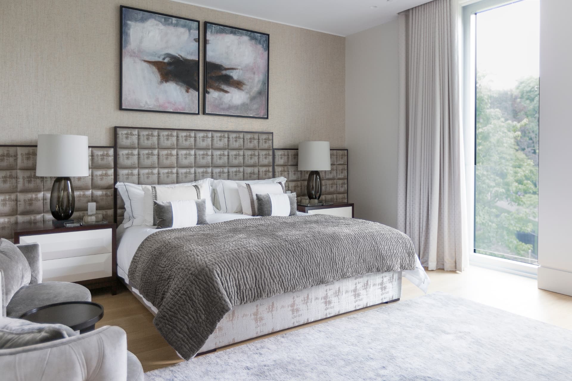 Principal bedroom with an upholstered panelled headboard and views to Holland Park.