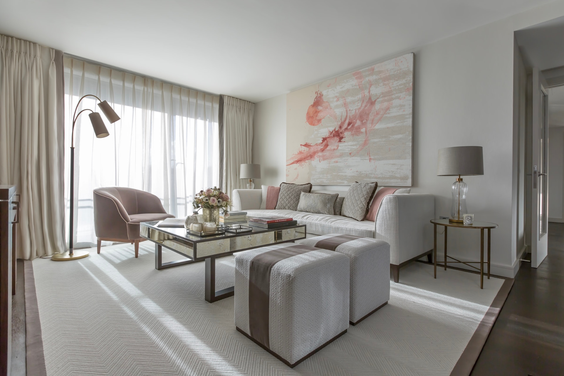 Grosvenor Waterside living room with a blush chair and abstract artwork.