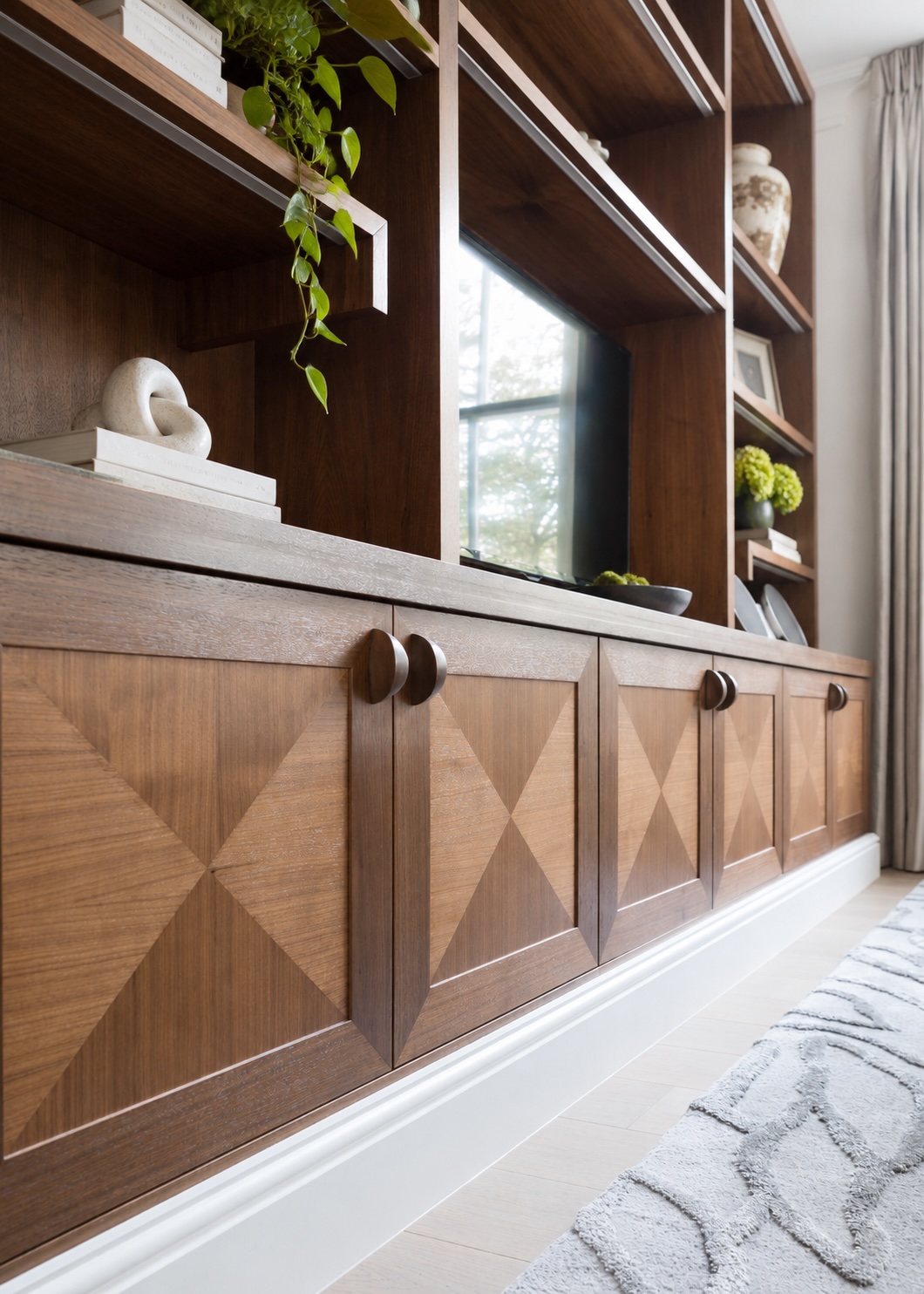 Side view of the bespoke walnut media joinery at Stanhope Gardens.